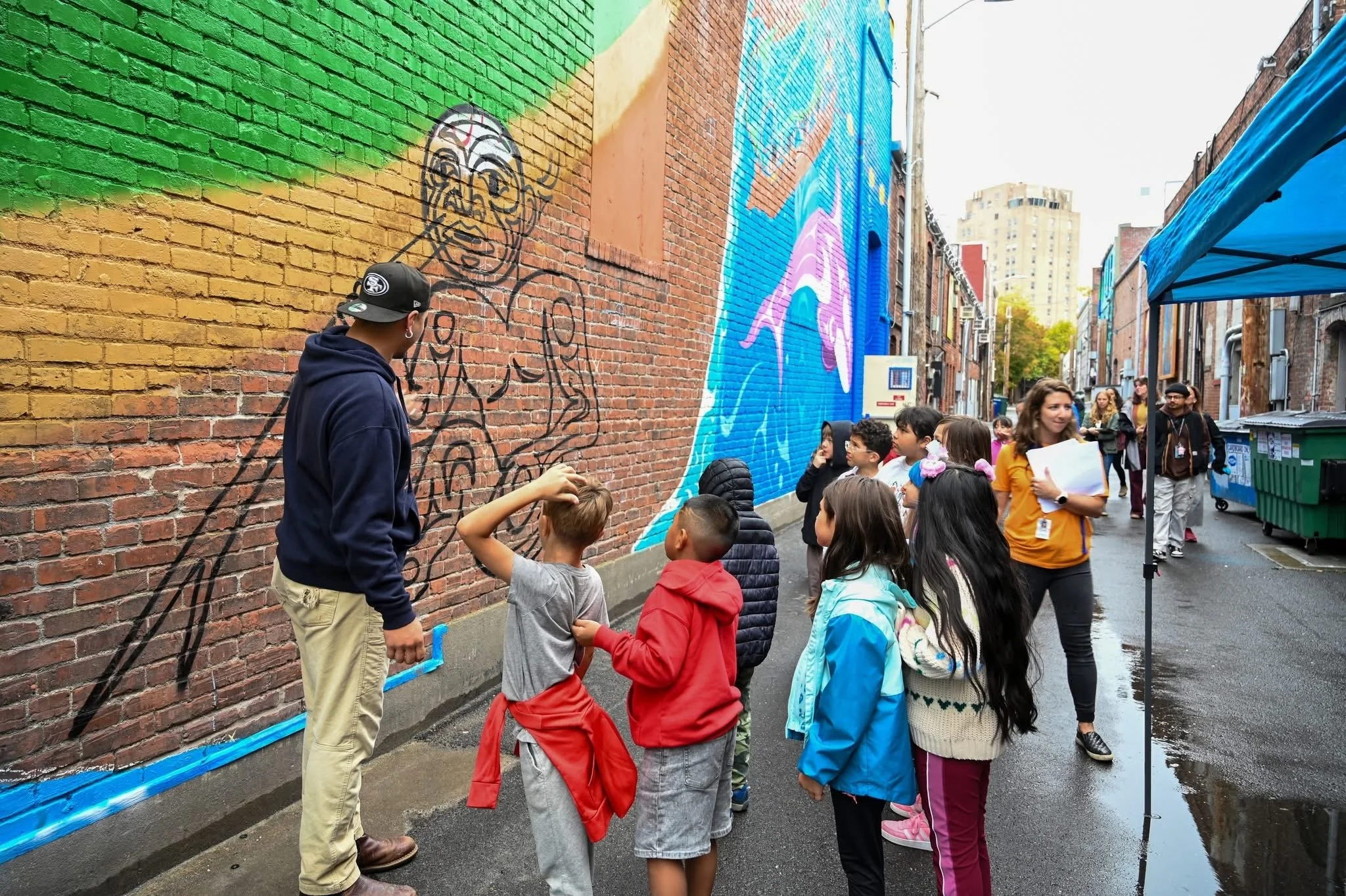 Free Borsey with children at the mural site