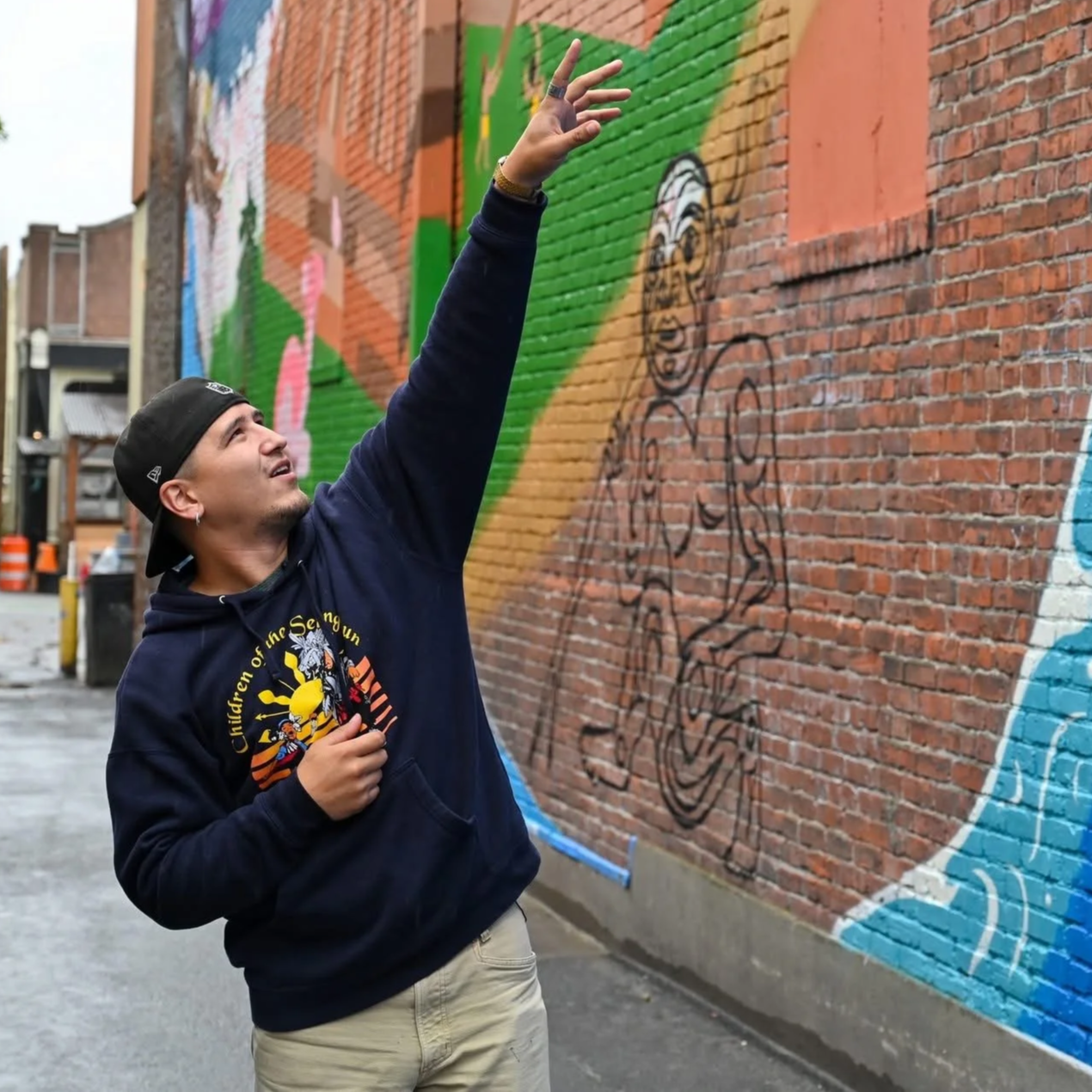 Free Borsey reaching toward the mural